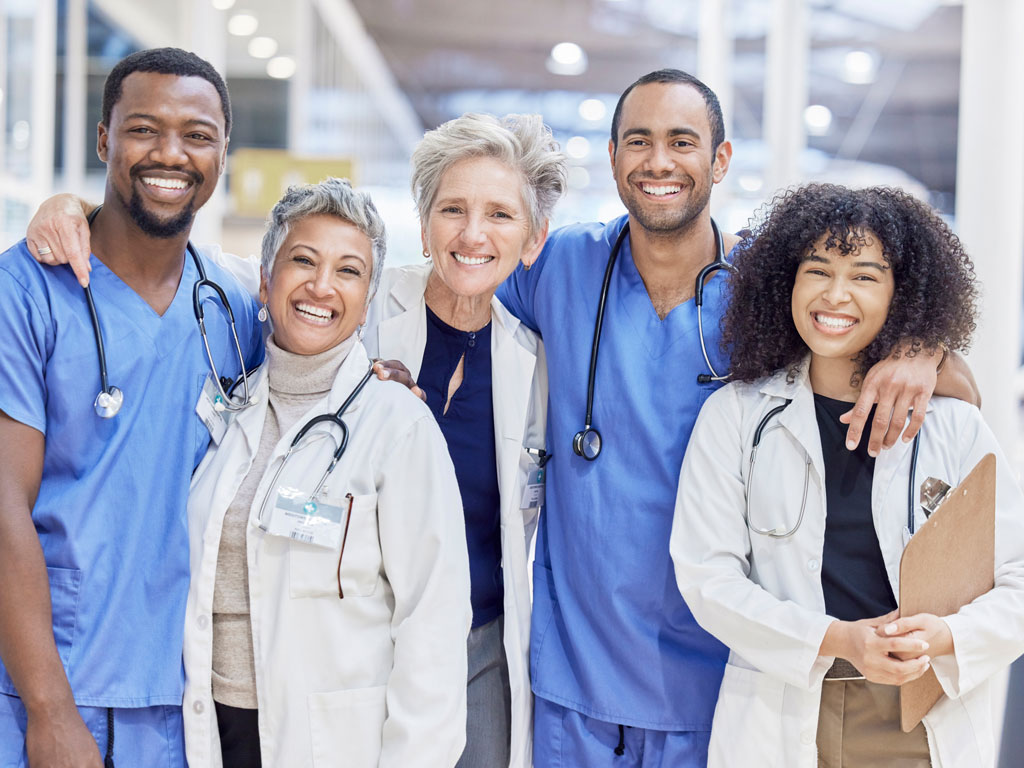 Happy portrait, group and doctors for healthcare service, leadership and teamwork in hospital diversity. Professional medical woman, mentor and internship nurses in clinic management, hug and support